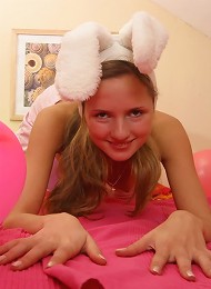 Lovely teen girl in bunny outfit exposing her small boobies